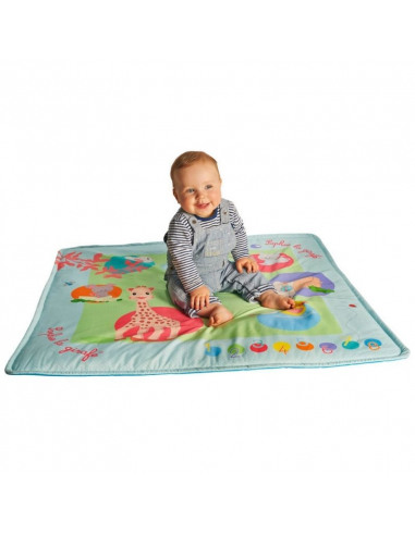 Touch & play mat'. Bebé encima de la alfombra de juego musical de color azul y con dibujos de Sophie la girafe